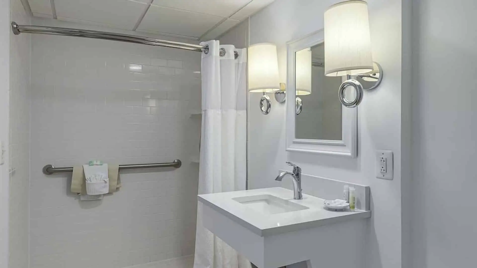 Classic King Suite ADA hotel room accessible bathroom sink area and roll in shower