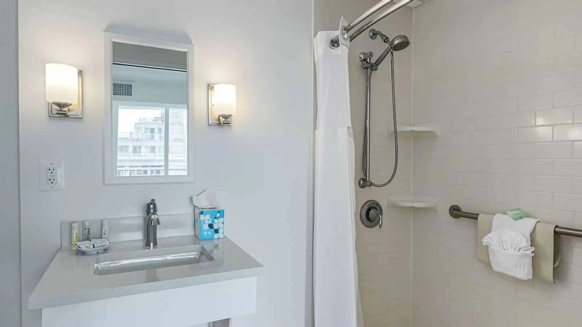 Classic King Suite ADA hotel room accessible bathroom sink area and roll in shower