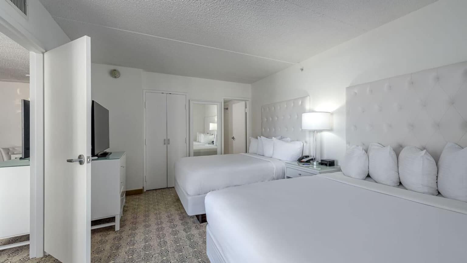 Premium poolside double suite hotel room beds