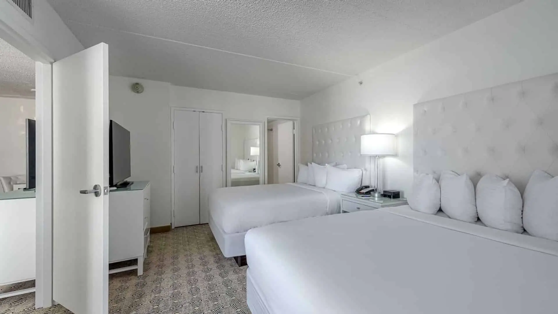Premium poolside double suite hotel room beds