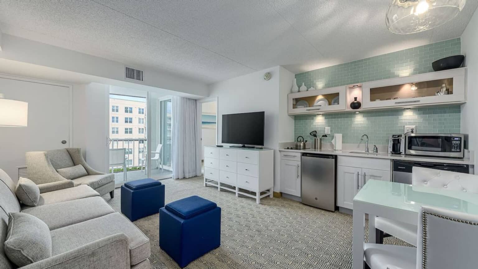 Premium poolside king suite hotel room living room and kitchen area