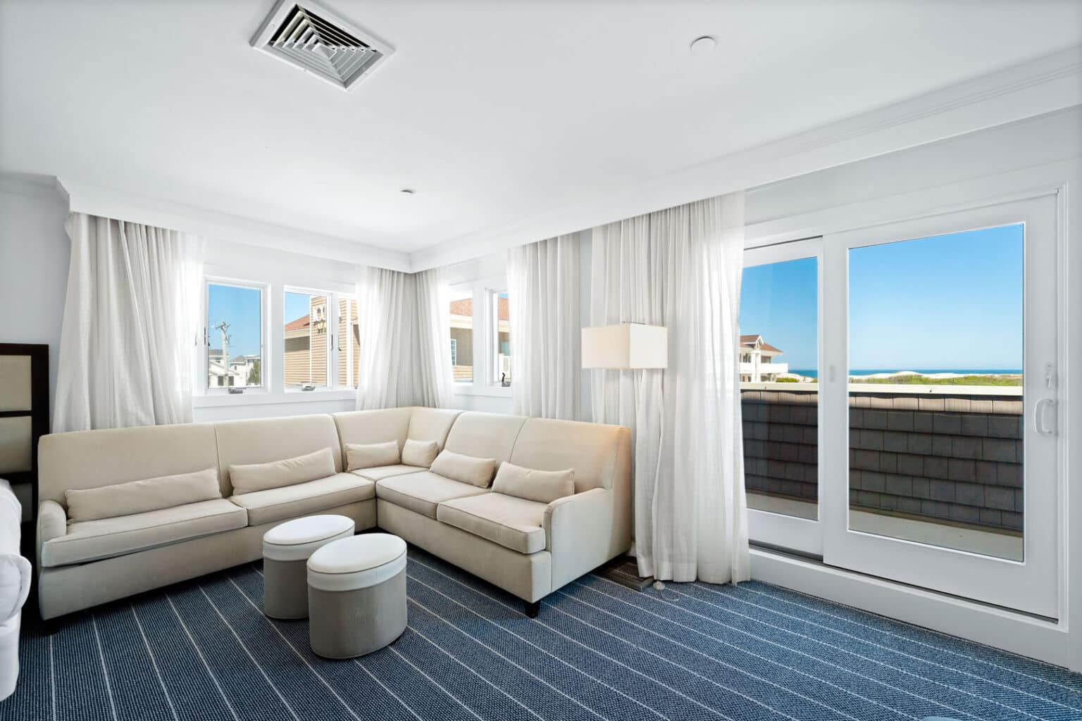 Premium family suite seating area and doors to balcony