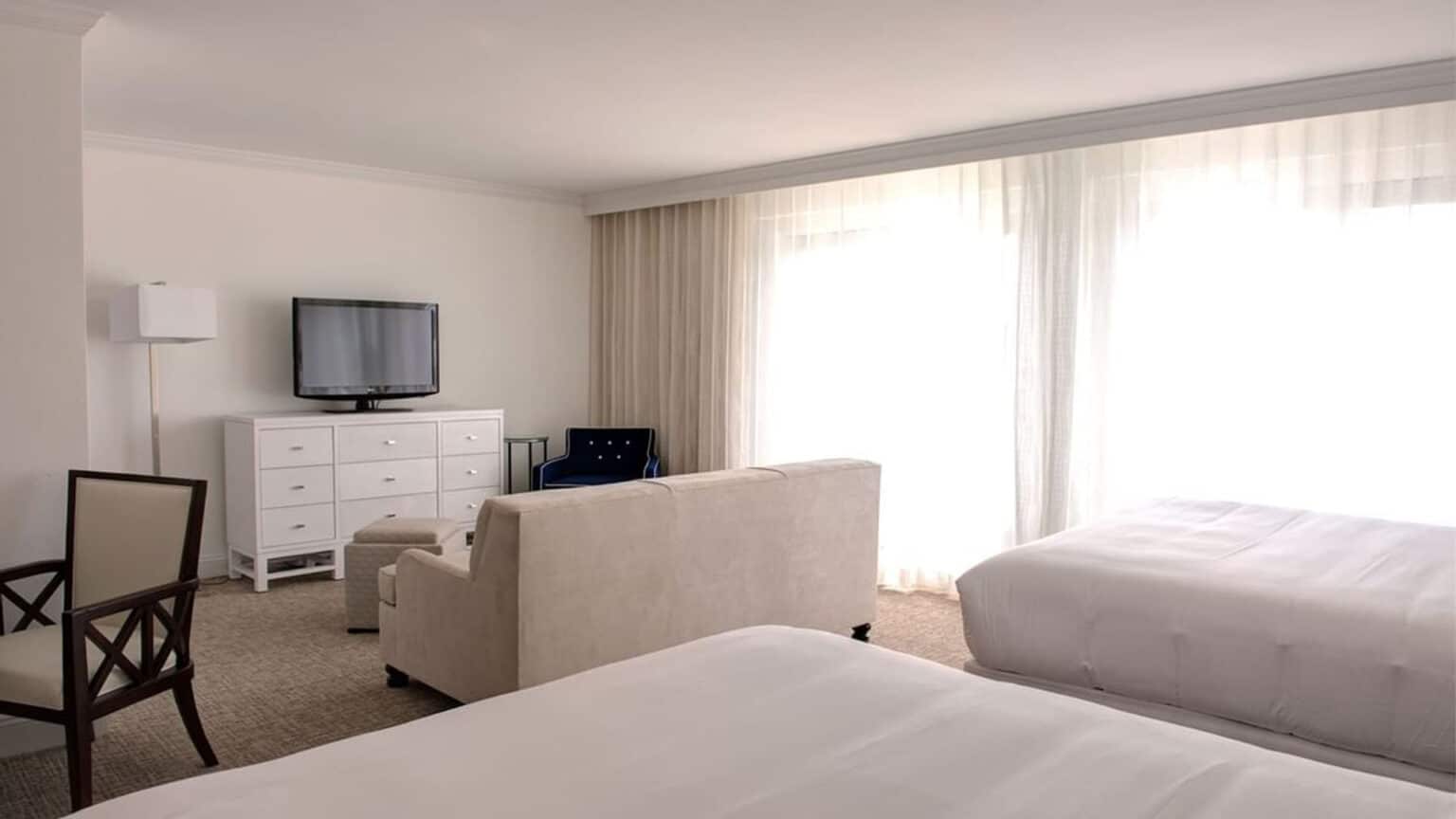 Premium poolside queen studio plus view of living area from the beds