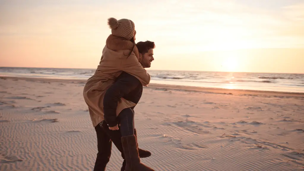 Couple on Avalon beach in the winter