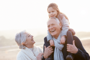 Grandparents with their grandchild on the beach in Spring Lake