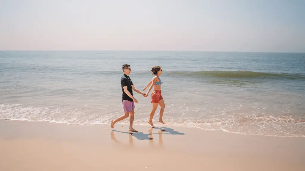Couple walking on the beach in Cape May, NJ