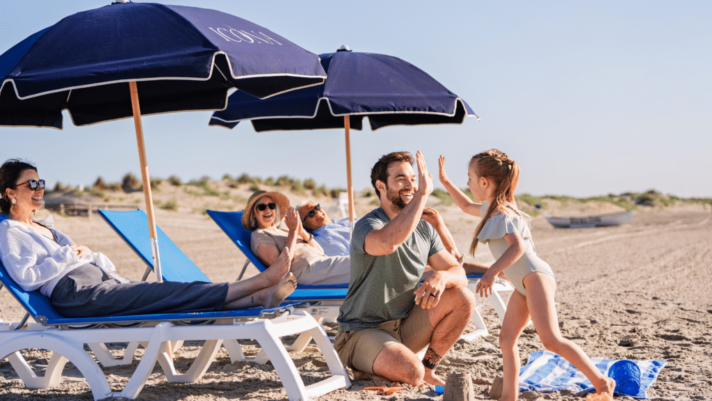 Family playing on the beach at ICONA Avalon