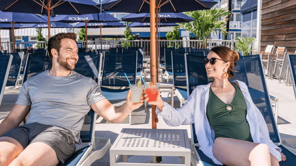 Couple enjoying drinks by the pool
