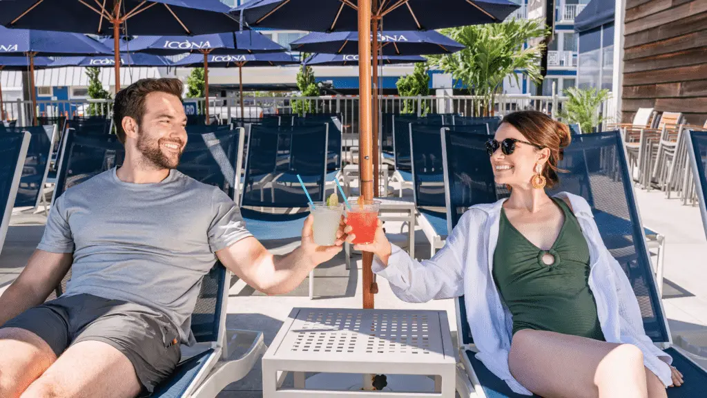 Couple enjoying drinks by the pool
