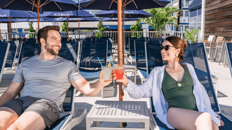 Couple enjoying drinks by the pool