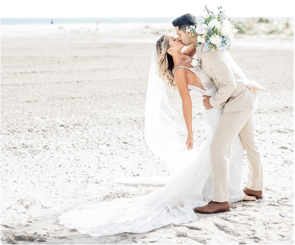 Bride and groom kissing on the beach