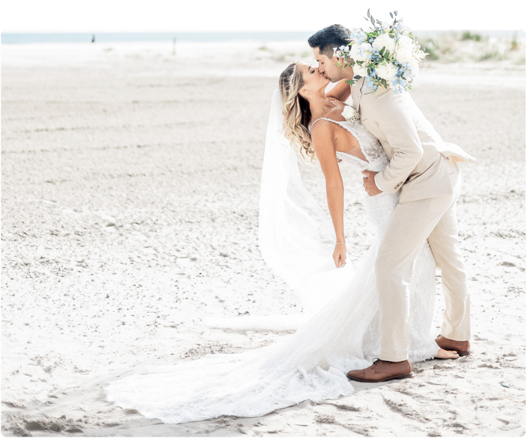 Bride and groom kissing on the beach