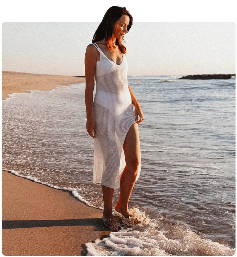 Woman standing on the beach looking at the ocean in Spring Lake, NJ
