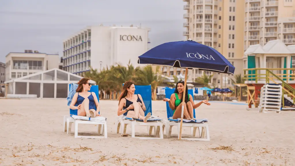 Three women lounging on ICONA Diamond Beach's private beach