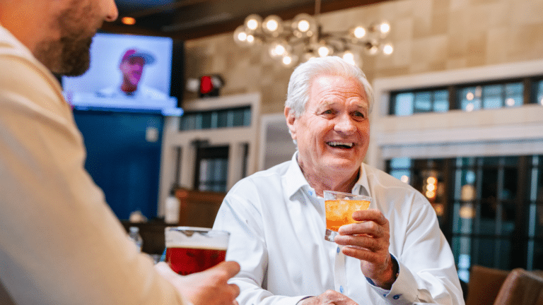 Two men enjoying a drink together on a guys trip