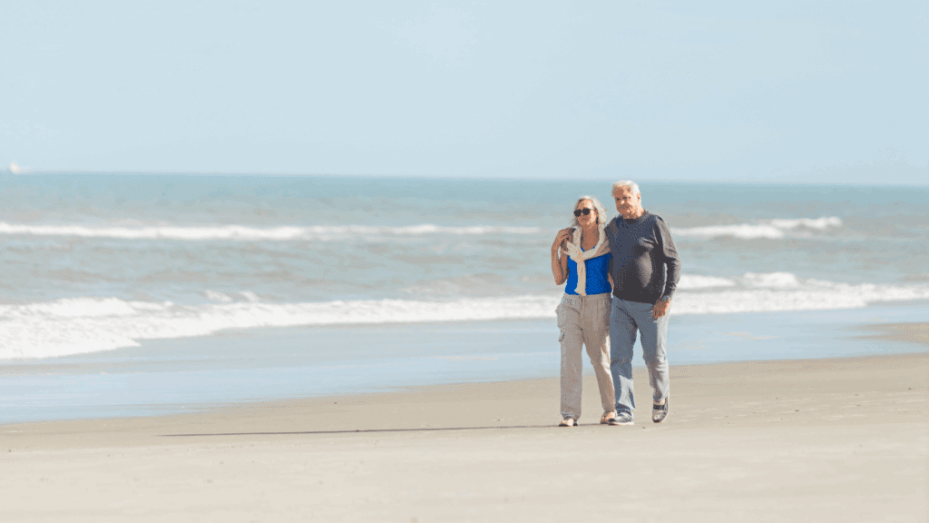 Older couple walking on the beach