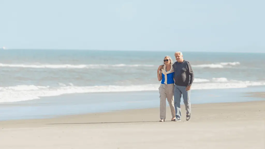 Older couple walking on the beach