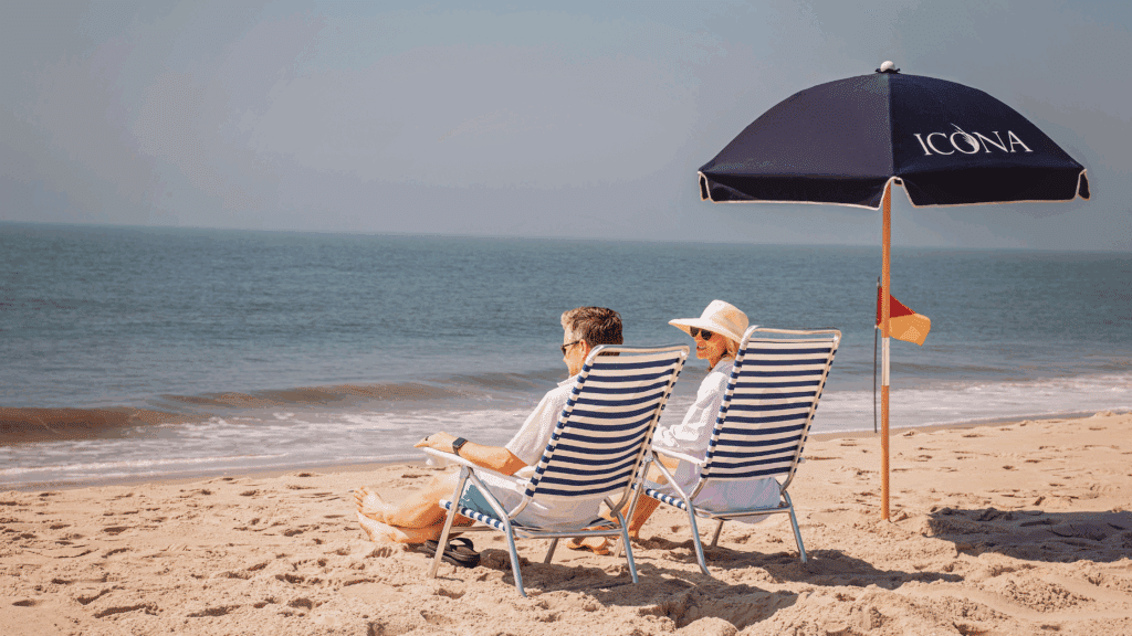 Couple sitting in ICONA beach chairs on a beach in NJ