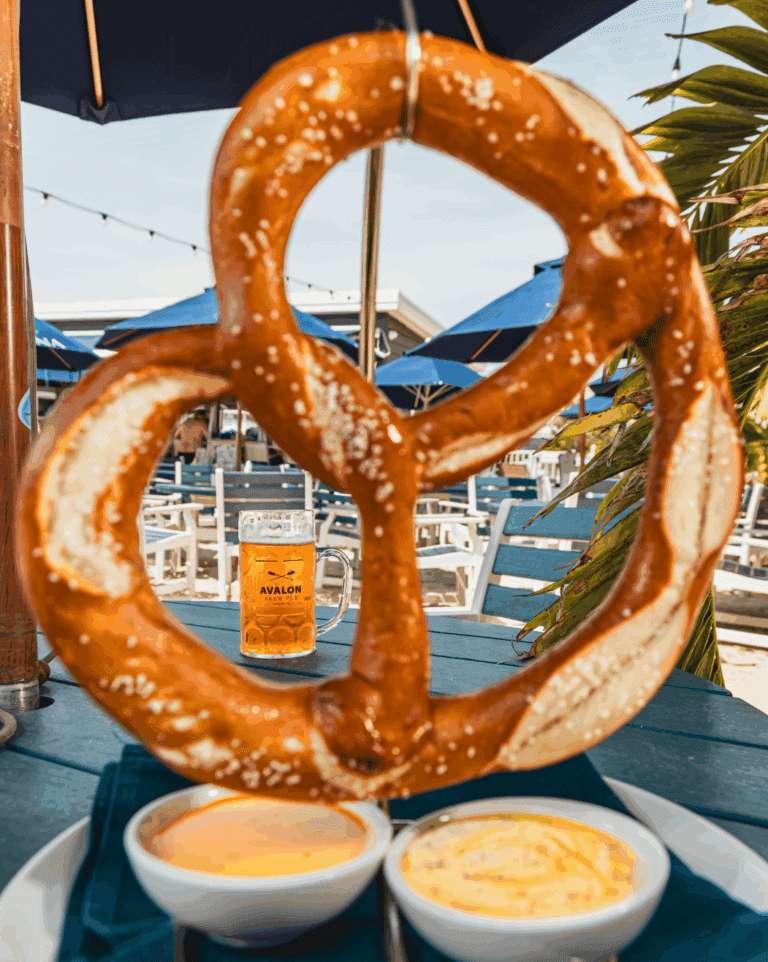 Mug of beer seen through the hole of a giant soft pretzel at ICONA's Oktoberfest