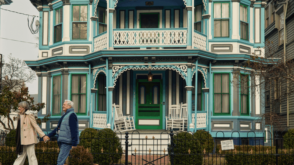 Couple walking in front of a Victorian home in Cape May
