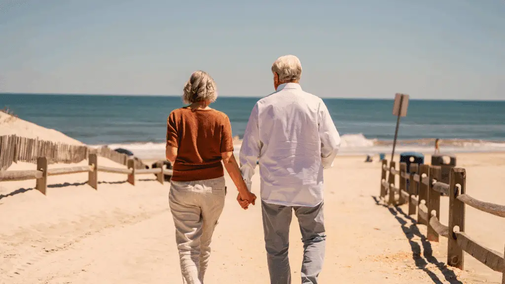 A couple walking on the beach in fall