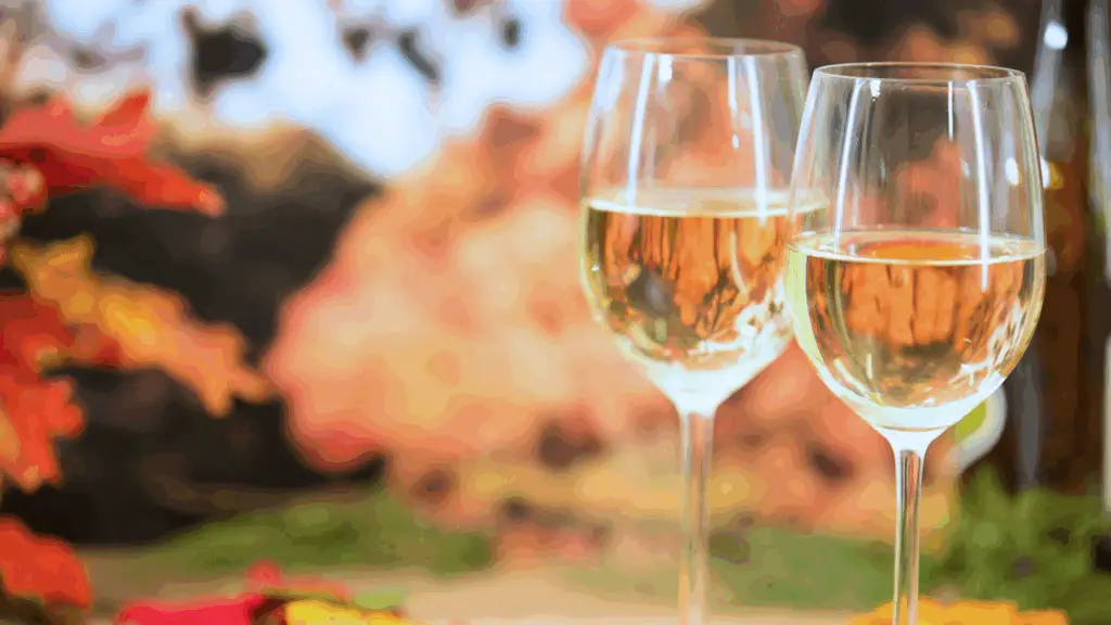 Two glasses of wine with a backdrop of fall foliage