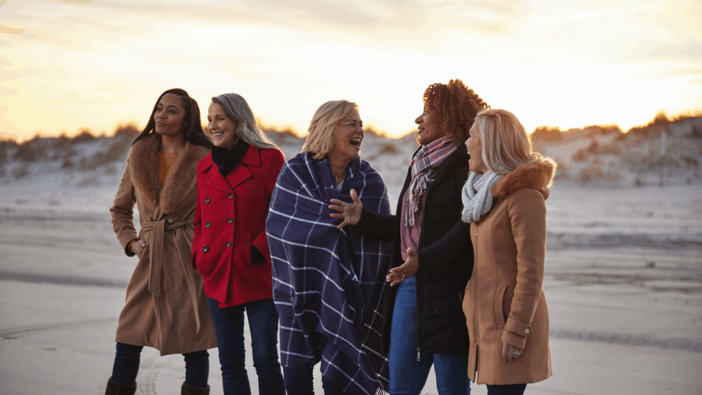 women walking and laughing together on the beach in Avalon, NJ