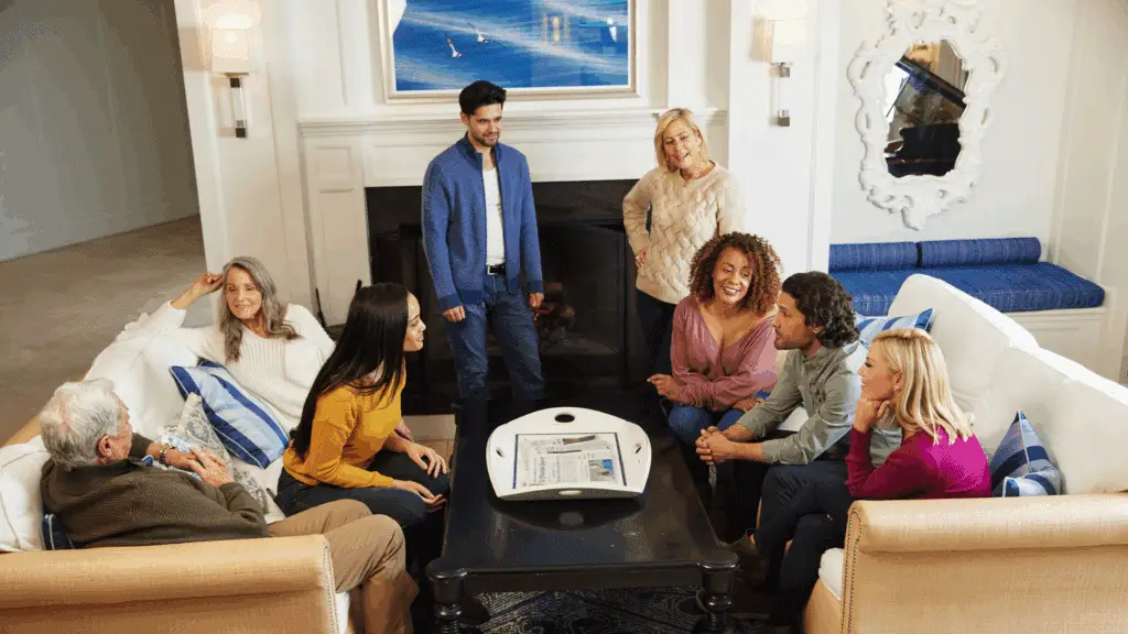 Group of family sitting around a fireplace at ICONA Avalon on Thanksgiving