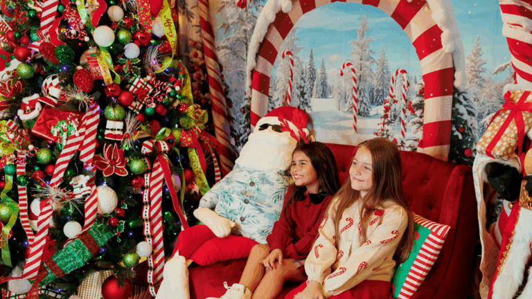 Two children posing for a photo at the Avalon, NJ Christmas takeover event