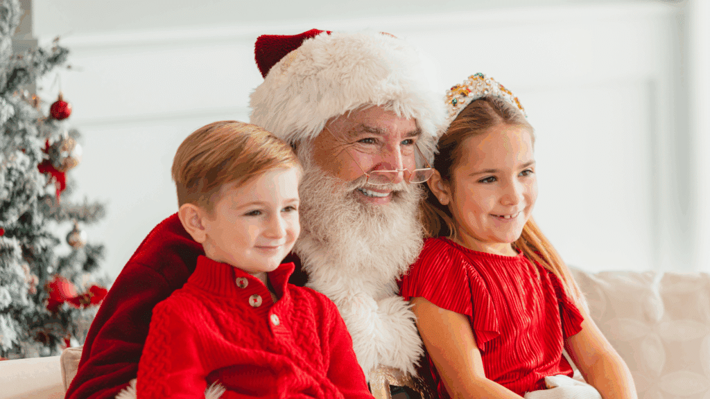 Santa Claus posing with two children