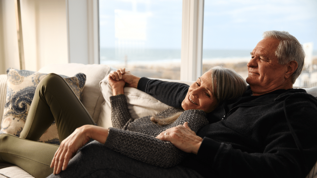 Couple cuddled up in a cozy hotel in Cape May, ICONA Cape May
