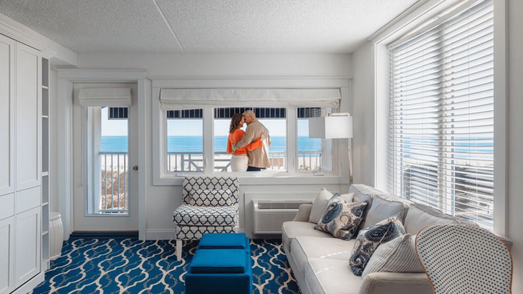 Couple in a hotel room in Cape May standing on their balcony