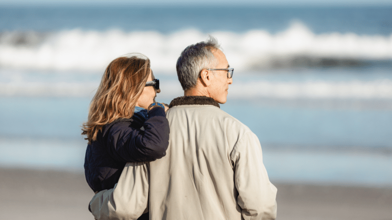 Couple embracing on the beach in winter